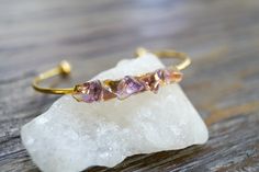 "Gemstone open gold bangle with pieces of Amethyst, Citrine, and Ametrine in variations of yellows and purple set on gold or silver that glows from beneath. The cuff is silver or gold and adjustable, I have two sizes s-m for wrist that is smaller than 6 1/2\", and med- large wrist size larger than 6 1/2\". The setting is 1 3/4\" long and a little over 1/4\" narrow, it is petite and slim. The cuff is stainless steel, silver or gold finish.  The bracelet is made with natural stone each one has sli Gold Amethyst Bracelets For Healing, Gold Amethyst Crystal Bracelet With Natural Stones, Purple Set, Open Bangle Bracelet, Raw Gemstone Jewelry, Open Bangle, Boho Bracelet, Star Bracelet, Gold Bangle