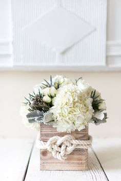 a bouquet of white flowers in a wooden box