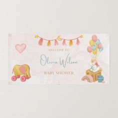 a welcome sign for a baby shower with balloons and animals on it's side