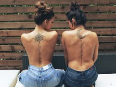 two women sitting on a bench with their back to the camera and tattoos on their backs