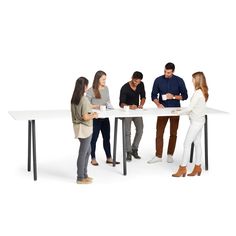 four people standing around a table looking at something on the paper in front of them