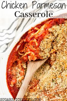 chicken parmesan casserole in a white dish with a wooden spoon