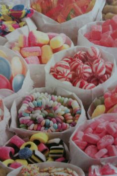 many different types of candies in paper bags