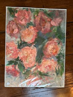 a painting of pink roses on a wooden table