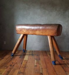 a wooden bench sitting on top of a hard wood floor