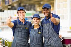 three workers giving the thumbs up sign