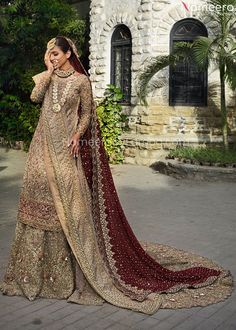 a woman in a bridal gown posing for the camera with her hand on her head