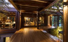 the inside of a house with wood flooring and glass doors leading to an outside deck