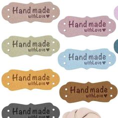 several different colored hand made tags with love written on each one and the other side