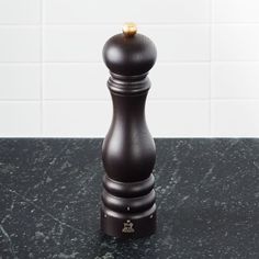 a black pepper mill sitting on top of a counter