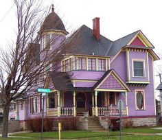 a purple house with two stories and a porch