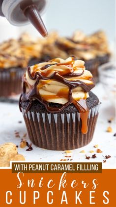 a chocolate cupcake with peanut caramel filling on top is being drizzled with icing