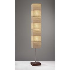 a lamp that is sitting on top of a wooden stand with a light in the middle