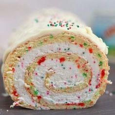 a cake roll with white frosting and sprinkles