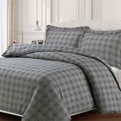 a black and white plaid comforter set on a bed