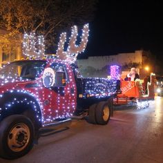 a truck decorated with christmas lights and reindeer antlers