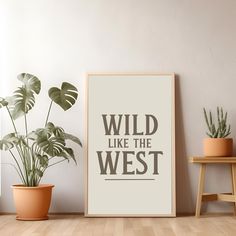 a poster with the words wild like the west on it next to potted plants