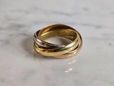 A WOMENS VINTAGE ESTATE 18K LES MUST DE CARTIER TRI COLORED GOLD TRINITY RING / PENDANT.  THE RING WEIGHS 7.7g, AND MEASURES 3/4" BY 1/2", AND IS A SIZE 6.5.   THIS MAKES A LOVELY GIFT FOR THAT SOMEONE SPECIAL.  ANY QUESTIONS PLEASE DO NOT HESITATE TO ASK. BE SURE TO CHECK OUT SOME OF MY OTHER GREAT ITEMS UP FOR SALE.  THANK YOU. Bidding Policy:  If you have less than 10 comments please email us first before bidding. There are too many new people bidding and not paying. Those who are, are still welcome just contact us first.  Thank you.    Payment Policy:  You have ten days to pay before we open an unclaimed item dispute.     Shipping & Handling Policy:  We ship within 1-3 days after payment is received and has been cleared.  Shipping & handling prices are AS IS.  If there is a problem wit Gold Trinity Ring, Cartier Trinity Ring, Trinity Ring, Ring Pendant, New People, Tri Color, Lovely Gift, Cartier, Pendant Necklaces