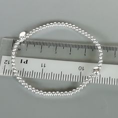 This is a sterling silver bracelet made with small beads. Diameter: 7.5 inches Beads: 2mm Big Bead: 5mm This bracelet is made of 925 hypoallergenic sterling silver. This piece is sent in a gift box. I can include a personal message from you if needed You are welcome to contact me at... bhavnakwintra1956@gmail.com For more beautiful pieces from my shop, please browse 👇 TOE RINGS: https://www.etsy.com/your/shops/TheSilverGame/tools/listings/section:27020628,view:table EAR HOOPS: https://www.etsy. Minimalist Sterling Silver Bracelet With Silver Beads As Gift, Dainty Silver Beaded Bracelet With Spacer Beads, Dainty Sterling Silver Bracelet With Silver Beads, Minimalist Sterling Silver Bracelets With Silver Beads, Silver Sterling Silver Beaded Bracelets, Silver Charm Bracelet With Silver Beads, Everyday Silver Charm Bracelet With Silver Beads, Sterling Silver Charm Bracelet With Silver Beads, Sterling Silver Bracelets With Silver Beads