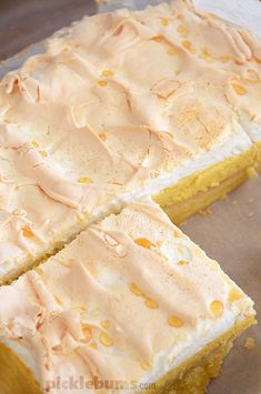 two pieces of cake sitting on top of a pan covered in frosted icing