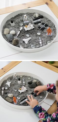 this is an image of a child playing with sand and rocks