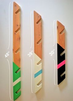 three wooden skis are hanging on the wall