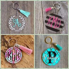 four different monogrammed keychains with tassels and letters on them