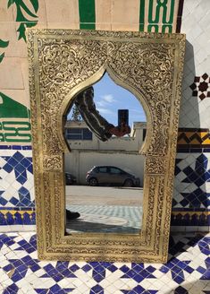 a mirror sitting on top of a tiled floor