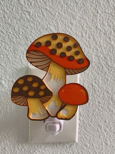 a mushroom light switch cover on a white wall