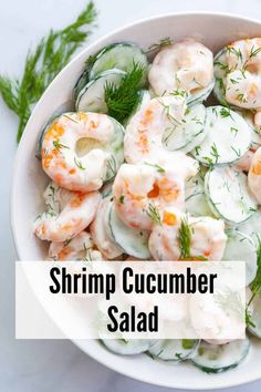 shrimp and cucumber salad in a white bowl with dill garnish