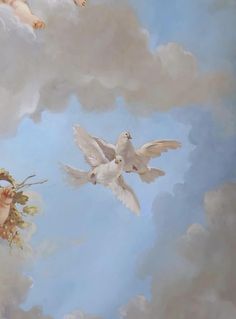 two white doves are flying in the sky with flowers and clouds behind them on a sunny day