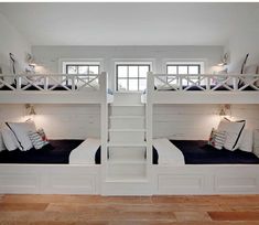 the bunk beds are all white and have pillows on them