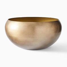 a gold bowl sitting on top of a white table