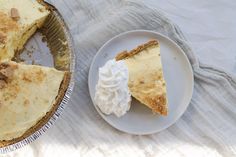 a piece of pie sitting on top of a white plate next to a cupcake