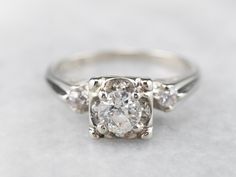 an engagement ring with three diamonds on it