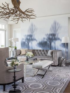 a living room with couches, chairs and a chandelier in the center