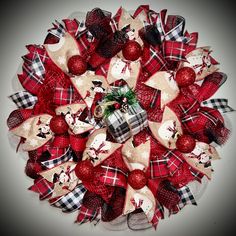 a christmas wreath made out of burlocks and bows