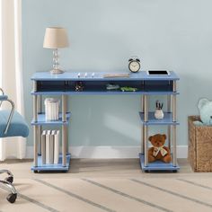 a blue desk with a teddy bear on it in a child's playroom