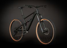 a black and orange bike on a dark background