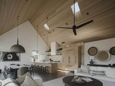 a living room filled with furniture and a ceiling fan