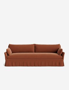 a brown couch sitting on top of a white wall