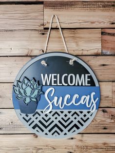 a welcome sign hanging on the side of a wooden wall that says, welcome success