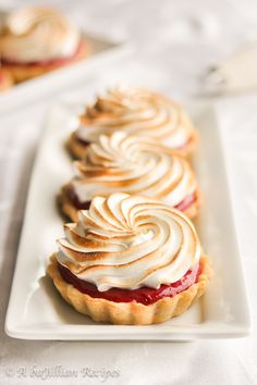 some desserts are sitting on a white plate