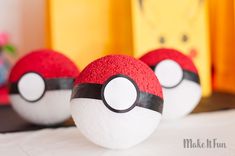 three pokeballs sitting on top of a table