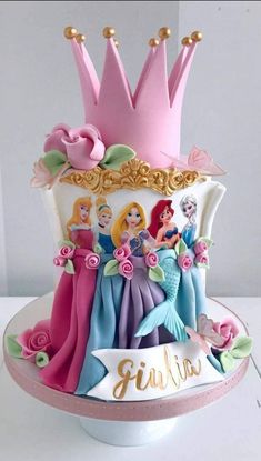 there is a cake with princesses on it