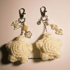 two crocheted key chains with charms attached to them