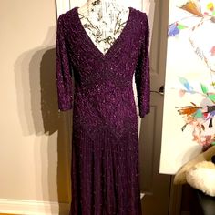 a purple dress on display in front of a mirror