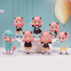 a group of figurines sitting on top of a table next to each other