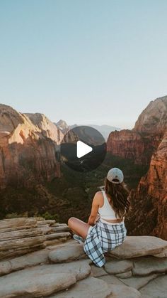 a woman sitting on top of a rock formation