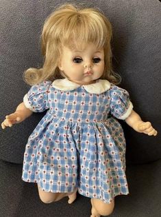 a doll that is laying down on a couch